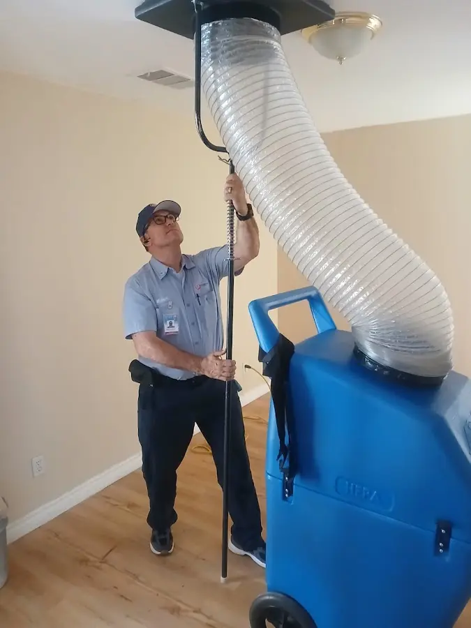 Furnace Tune-Up technician using HEPA equipment in Brushy Creek