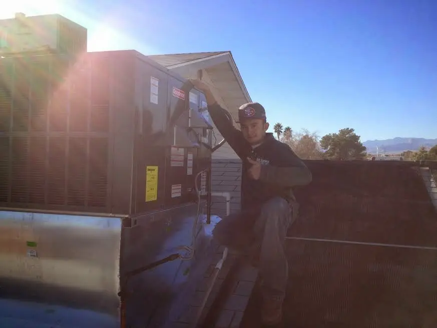 HVAC technician performing Boiler Repair on a rooftop unit in Brushy Creek